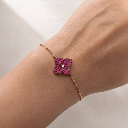 1.02 carats Deep&nbsp;Pink Sapphires
0.04 carats&nbsp;Center Round White Diamond
Bracelet&nbsp;Set in 18K Rose and Black&nbsp;Gold
Flower Motif: 12mm X 12mm
Bracelet Length 6.75 inches