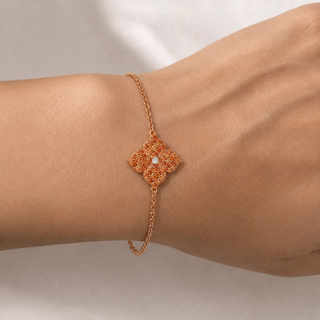 0.94&nbsp;carats Round Orange Sapphire
0.04&nbsp;carats&nbsp;center Round White Diamond
Bracelet&nbsp;Set in 18K Rose Gold
Flower Motif: 12mm X 12mm
Bracelet Length 6.75