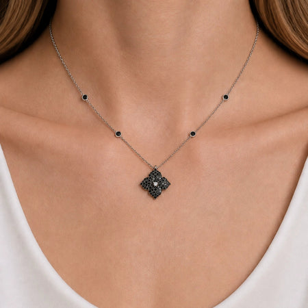 Approx. 1.40 carats Round&nbsp;Black Diamonds
Diamond Center
Pendant Set in 18K&nbsp;White and Black Gold
Color Diamond Chain Included
Pendant Measures: 12mm X 12mm
Necklace Measures: 17 inches