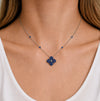 Approx. 1.60 carats Round&nbsp;Blue Sapphires
Diamond Center
Pendant Set in 18K White and Black Gold
Color Stone Chain Included
Pendant Measures: 12mm X 12mm
Necklace Measures: 17 inches