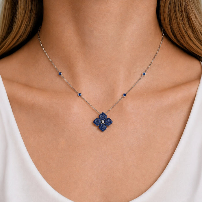 Approx. 1.60 carats Round&nbsp;Blue Sapphires
Diamond Center
Pendant Set in 18K White and Black Gold
Color Stone Chain Included
Pendant Measures: 12mm X 12mm
Necklace Measures: 17 inches